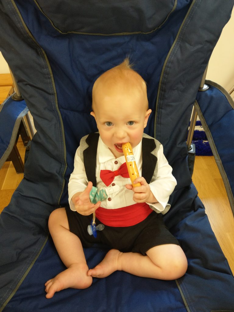 infant in a tuxedo babygrow