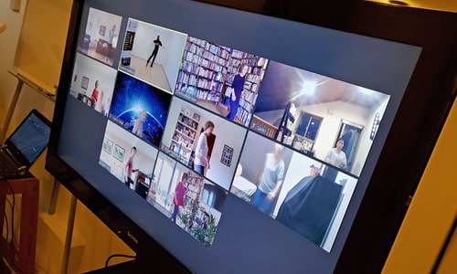 photo of a TV screen showing a zoom worldwide dance class with various screens of people taking part in dance classes & lessons (including from Japan & Denmark!)