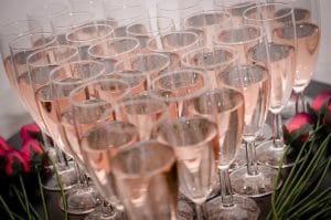 Champagne flutes filled with rose prosecco in a heart formation