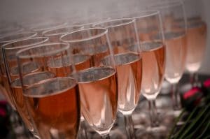 Close up of champagne flutes filled with rose prosecco