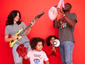 Comic Relief Silent Social. Official Comic Relief photo showing a family playing inflatable instruments