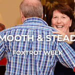 A couple in a Ballroom hold, the leader shown from behind and the follower smiling over the leader's shoulder. Overlaid the text "Smooth & Steady" above "Foxtrot Week" and the Learn To Dance logo in the bottom right corner