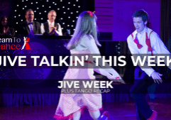 A couple dancing a Jive move facing each other. Judges watch in the background