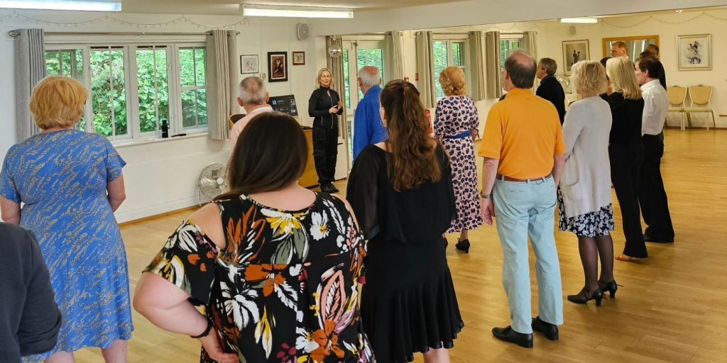 Image of a Latin American dance workshop with Strictly legend Kristina Rihanoff. Image shows a dance studio with a number of students facing a teacher